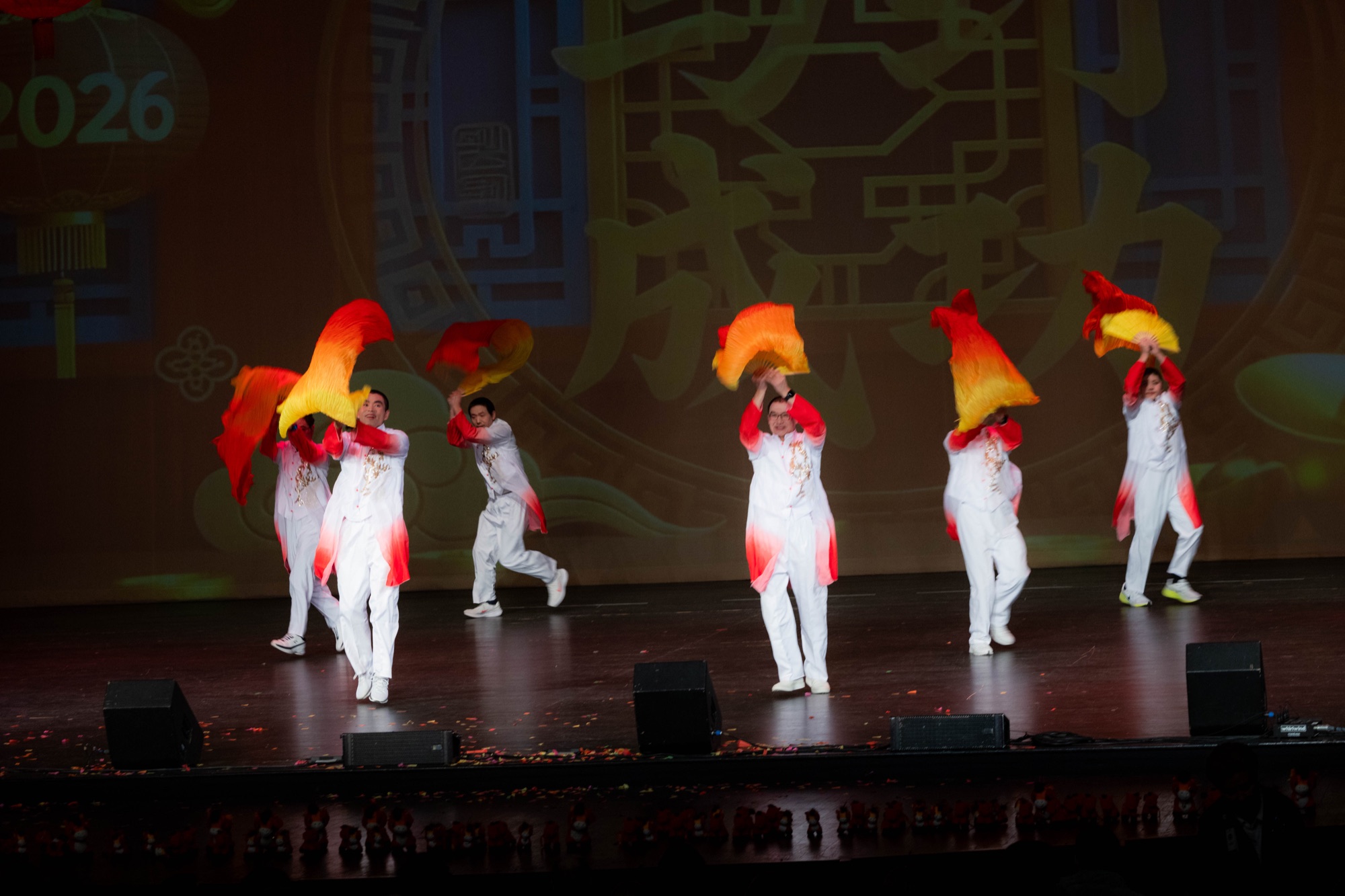 Dancers in red and white costumes performing onstage