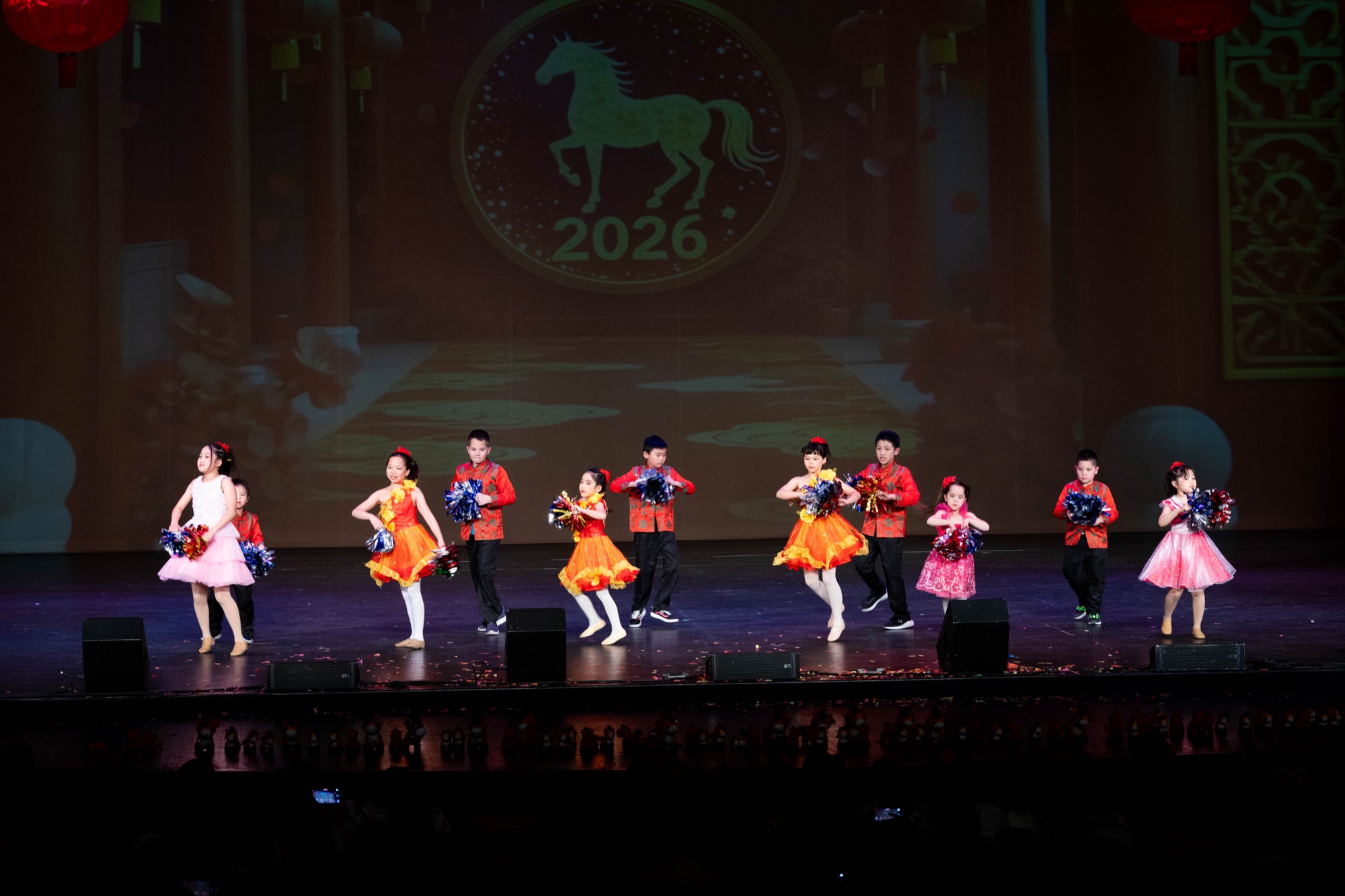 Young dancers performing together on a decorated stage